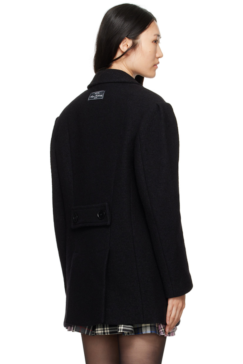 Oversized virgin wool bouclé coat. 

· Notched lapel
· Double-breasted button closure
· Welt pockets
· Padded shoulders
· Logo patch at back collar
· Button tab at back
· Twin vents at back hem
· Full logo-woven viscose satin lining

Supplier color: Black