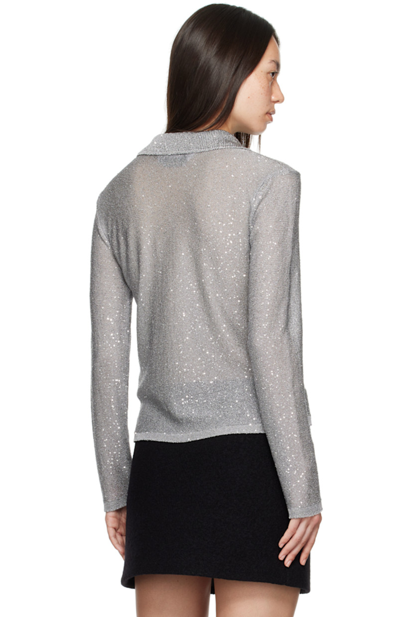 Knit polyester polo. Sequins throughout. 

· Rib knit spread collar, hem, and cuffs
· Three-button placket
· Unlined

Supplier color: Grey