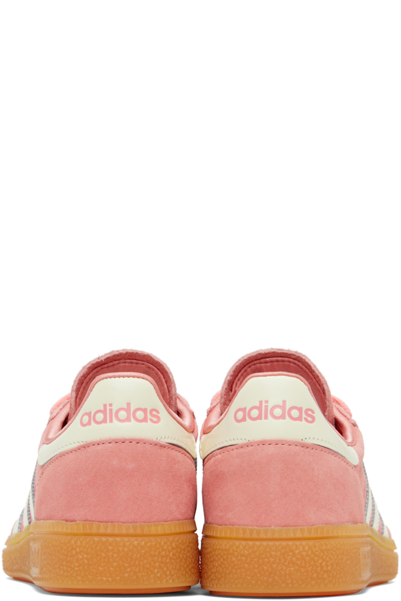 Low-top suede and buffed leather sneakers in pink and white.

· Lace-up closure
· Logo patch at tongue 
· Signature serrated stripes at sides
· Logo stamp at outer side and heel
· Treaded rubber sole

Part of the Sporty & Rich x adidas Originals collaboration. 

Supplier color: Pantone/Cream white/Gum