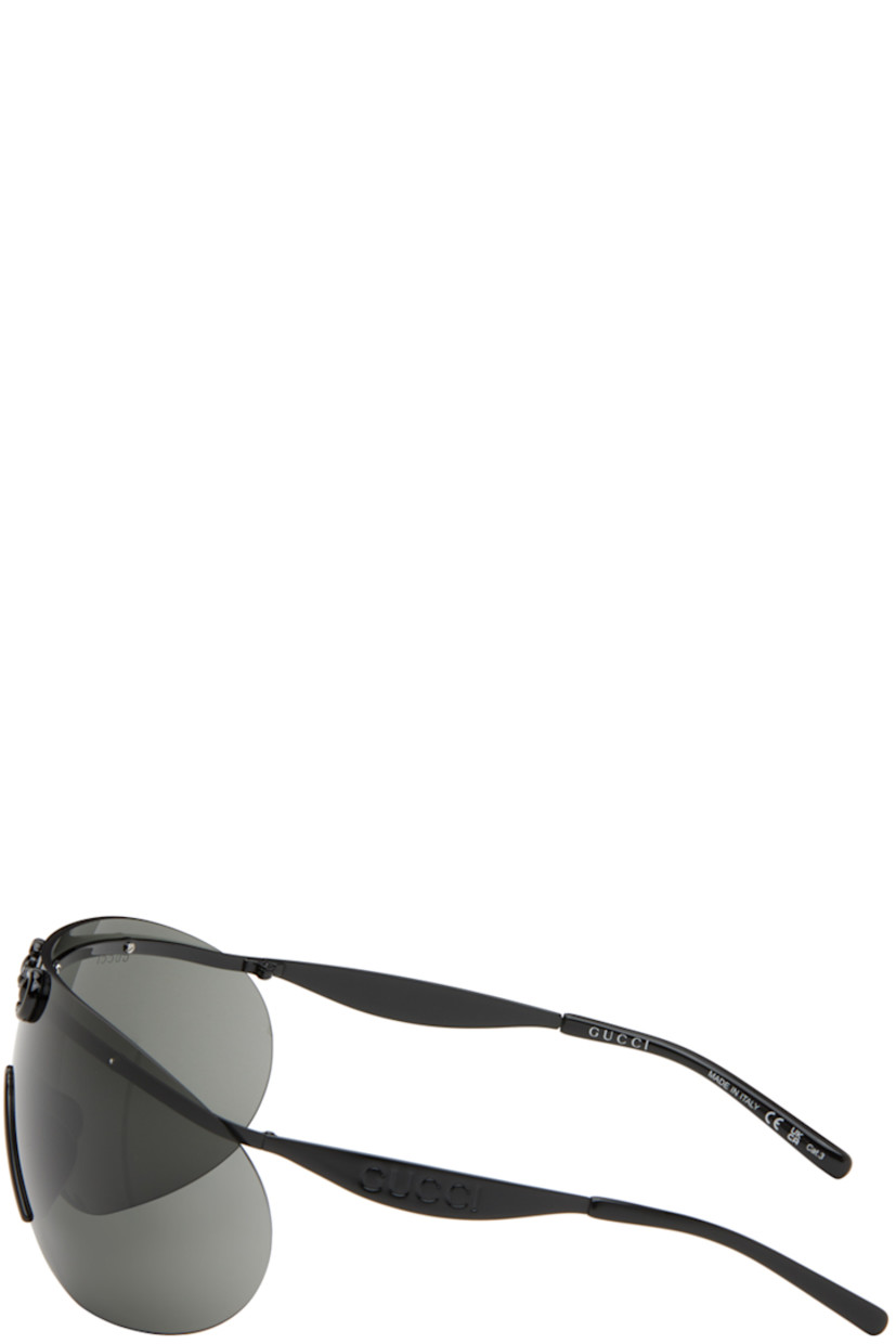 Shield-style rimless metal-frame sunglasses in black.

· Horsebit hardware at face 
· Gray lens
· 100% UVA/UVB protection 
· Logo etched at lens
· Integrated nose pads
· Logo embossed at temples
· Includes case
· Size: 99.1 125

Supplier color: Black