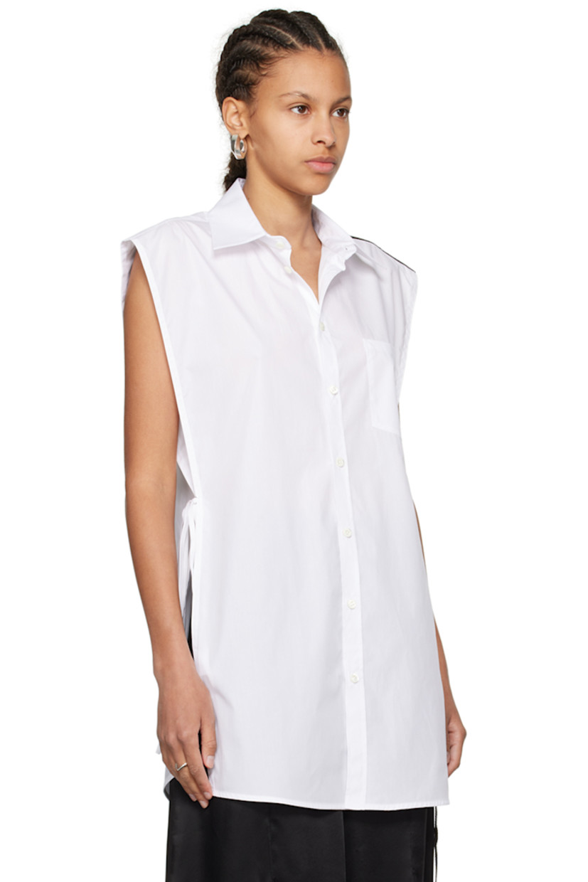 Cotton poplin vest-style shirt.

· Spread collar
· Button closure
· Patch pocket
· Shirttail hem
· Self-tie fastening at open side seams

Supplier color: White