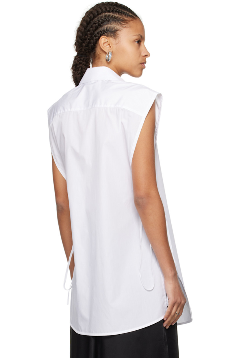 Cotton poplin vest-style shirt.

· Spread collar
· Button closure
· Patch pocket
· Shirttail hem
· Self-tie fastening at open side seams

Supplier color: White