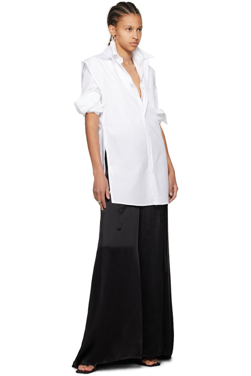 Cotton poplin vest-style shirt.

· Spread collar
· Button closure
· Patch pocket
· Shirttail hem
· Self-tie fastening at open side seams

Supplier color: White
