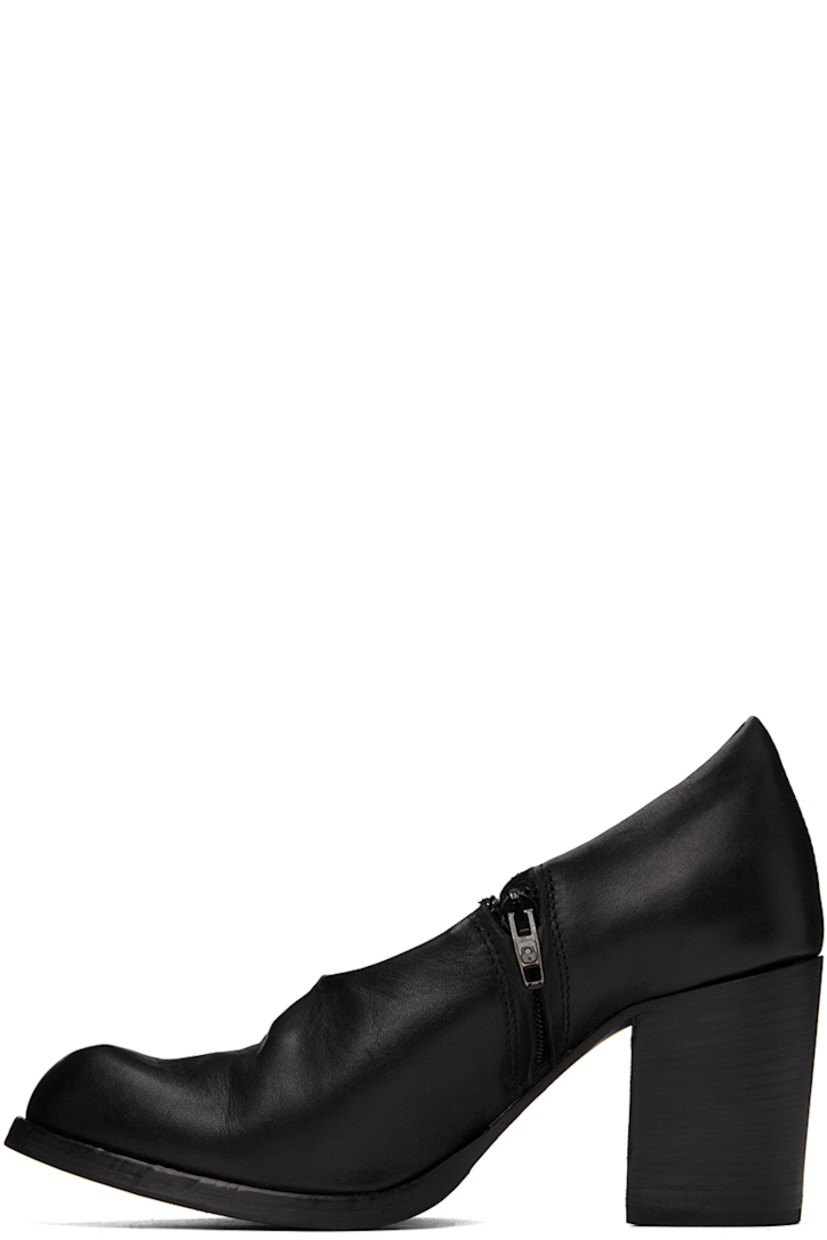 Handcrafted grained leather heels in black.

· Subtle distressing throughout
· Zip closure at inner side
· Padded leather footbed
· Buffed leather and suede lining
· Stacked leather block heel with rubber injection 
· Rubber sole
· Heel: H3"

Part of the Edward Cuming x Adam Signature collaboration. 

Supplier color: Black