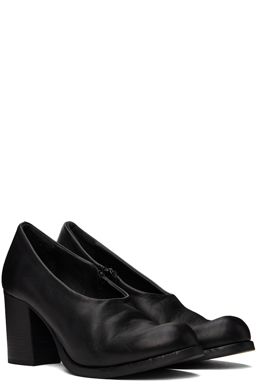 Handcrafted grained leather heels in black.

· Subtle distressing throughout
· Zip closure at inner side
· Padded leather footbed
· Buffed leather and suede lining
· Stacked leather block heel with rubber injection 
· Rubber sole
· Heel: H3"

Part of the Edward Cuming x Adam Signature collaboration. 

Supplier color: Black