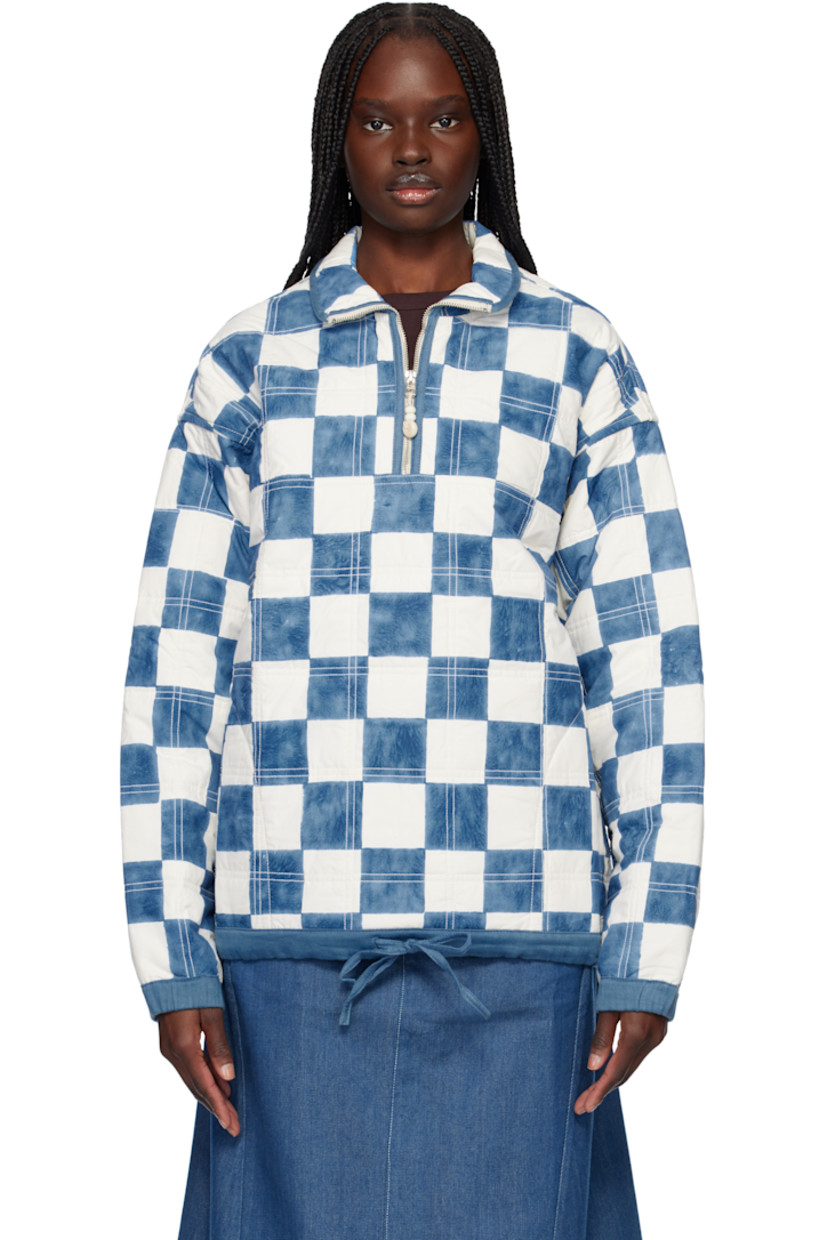 Handcrafted quilted organic cotton poplin jacket. Hand block-printed check pattern throughout. 

· Stand collar
· Half-zip closure
· Crocheted logo at chest
· Drawstring at hem
· Elasticized cuffs
· Full quilted poplin lining
· Corozo nut hardware

Supplier color: Arctic checker