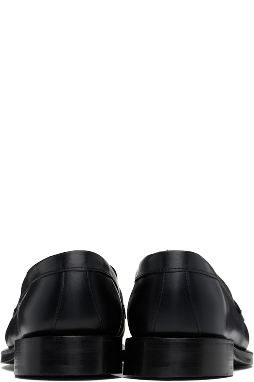 Handcrafted buffed leather loafers in black.

· Moc toe
· Strap with cutout at vamp
· Logo embossed at padded leather footbed
· Buffed leather and suede lining
· Topstitching at Goodyear welt
· Stacked leather block heel with rubber injection
· Polished leather sole

Supplier color: Black