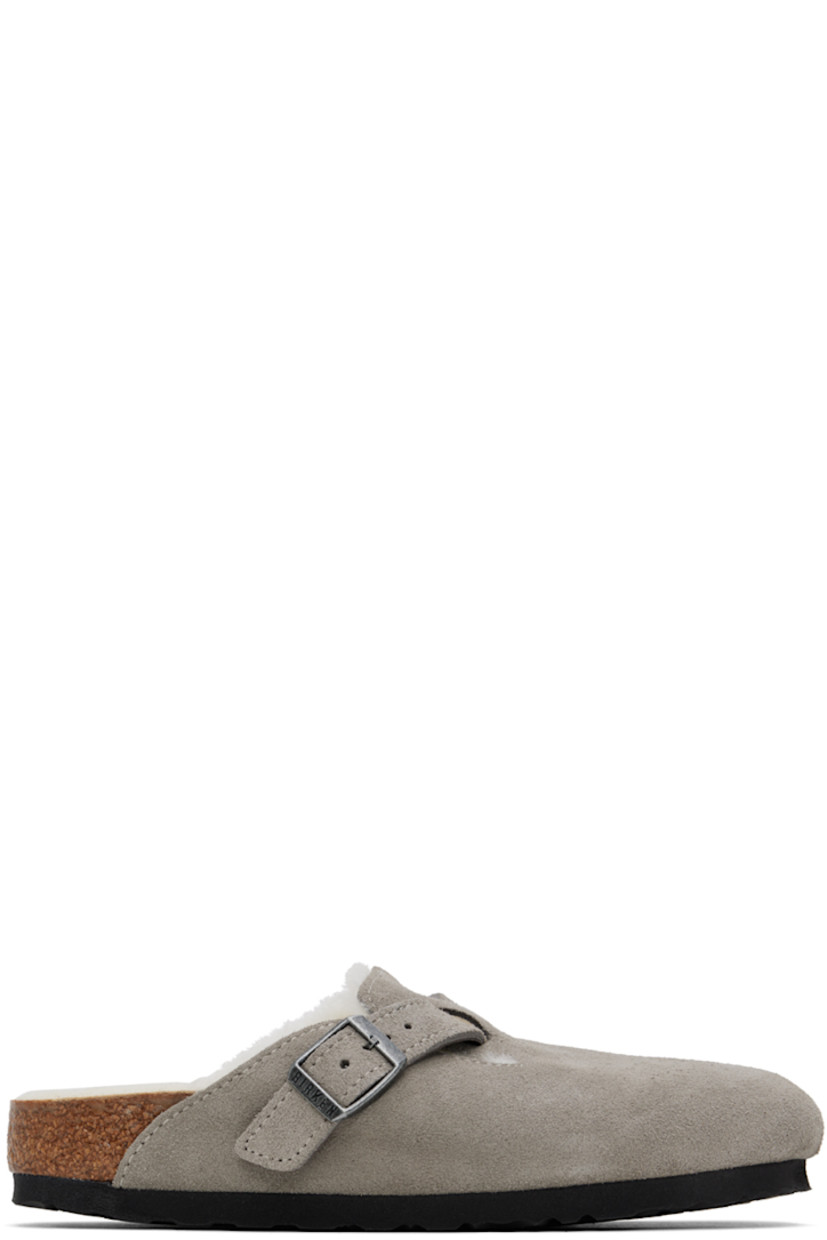 Suede slip-on loafers in gray.

· Pin-buckle strap at vamp
· Logo embossed at inner side
· Molded cork footbed
· Shearling lining
· Cork midsole
· Treaded EVA foam rubber sole
· Logo-engraved antiqued silver-tone hardware

Supplier color: Stone coin/Natural