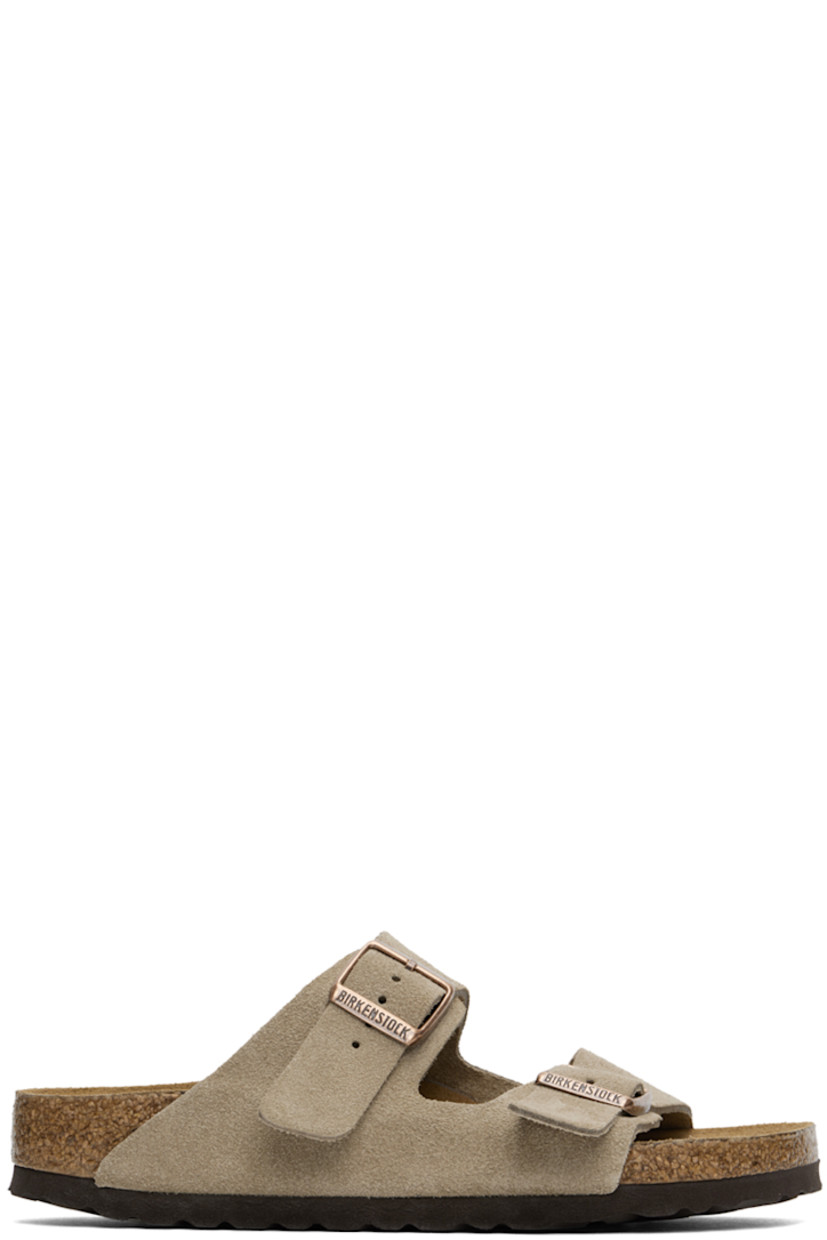 Suede slip-on sandals in taupe.

· Open toe
· Pin-buckle straps at vamp
· Logo embossed at inner side
· Logo embossed at cushioned molded suede footbed
· Cork midsole
· Treaded EVA foam rubber sole
· Logo-engraved antiqued copper-tone hardware

Supplier color: Taupe
