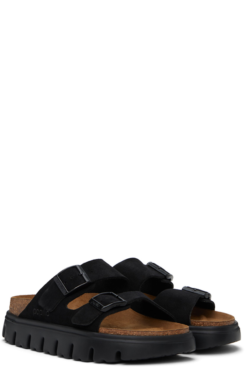 Suede slip-on sandals in black.

· Open round toe
· Adjustable pin-buckle straps at vamp
· Logo embossed at outer side
· Logo stamped at molded footbed
· Latex-cork platform midsole
· Treaded EVA foam rubber sole
· Logo-engraved black hardware
· Platform: H1"

Part of the Papillio collection.

Supplier color: Black