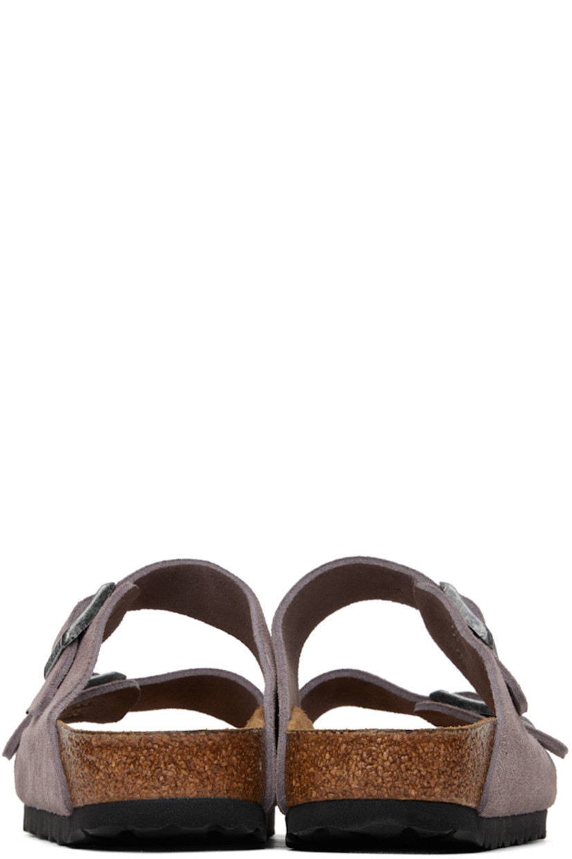 Suede slip-on sandals in purple. 

· Open toe
· Pin-buckle straps at vamp
· Logo embossed at inner side
· Logo stamp at molded suede footbed
· Cork midsole
· Treaded EVA rubber sole
· Logo-engraved antiqued silver-tone hardware

Supplier color: Faded purple
