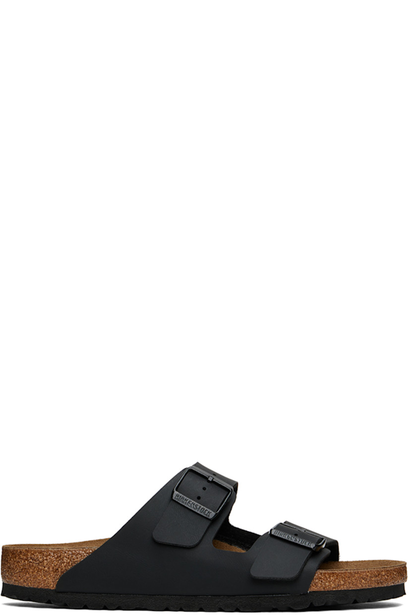 Grained Birko-Flor® faux-leather slip-on sandals in black.

· Open toe
· Pin-buckle straps at vamp
· Logo embossed at inner side
· Logo stamp at molded suede footbed
· Latex-cork midsole
· Treaded EVA outsole
· Logo-engraved black hardware

Supplier color: Black