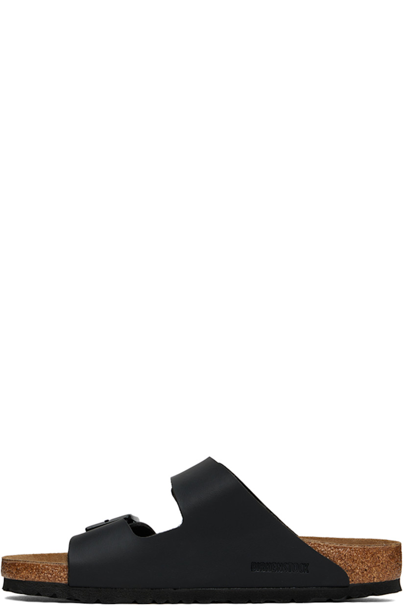 Grained Birko-Flor® faux-leather slip-on sandals in black.

· Open toe
· Pin-buckle straps at vamp
· Logo embossed at inner side
· Logo stamp at molded suede footbed
· Latex-cork midsole
· Treaded EVA outsole
· Logo-engraved black hardware

Supplier color: Black