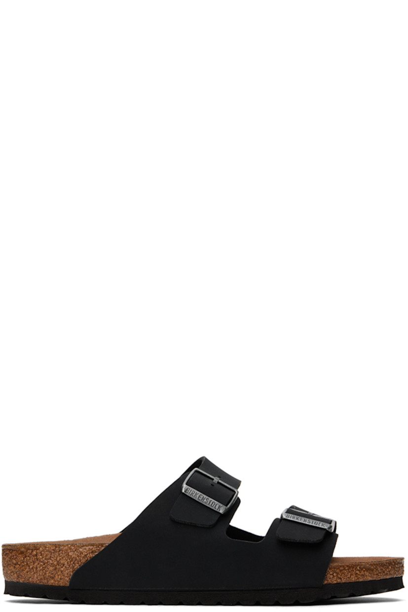 Buffed Birkibuc® faux-leather slip-on sandals in black. 

· Open toe
· Pin-buckle straps at vamp
· Logo embossed at inner side
· Logo stamp at molded microfiber footbed
· Cork midsole
· Treaded EVA rubber sole
· Logo-engraved antiqued silver-tone hardware

Supplier color: Vegan black