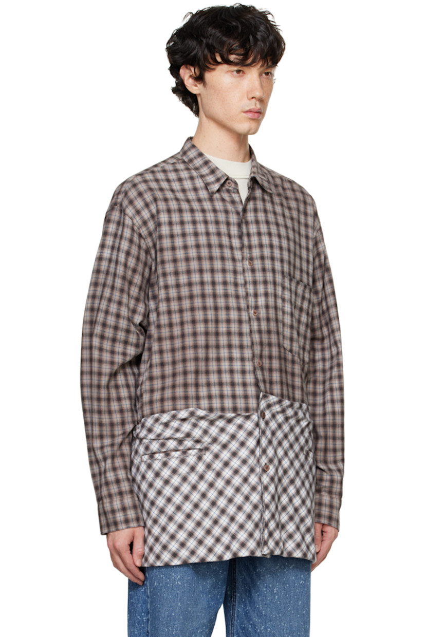 Overdyed cotton flannel shirt. Check pattern throughout.

· Spread collar
· Button closure
· Patch pocket at chest
· Welt pockets
· Drawstring and patch pockets at hem
· Pleats at single-button barrel cuffs
· Box pleat at back yoke

Supplier color: Brown check