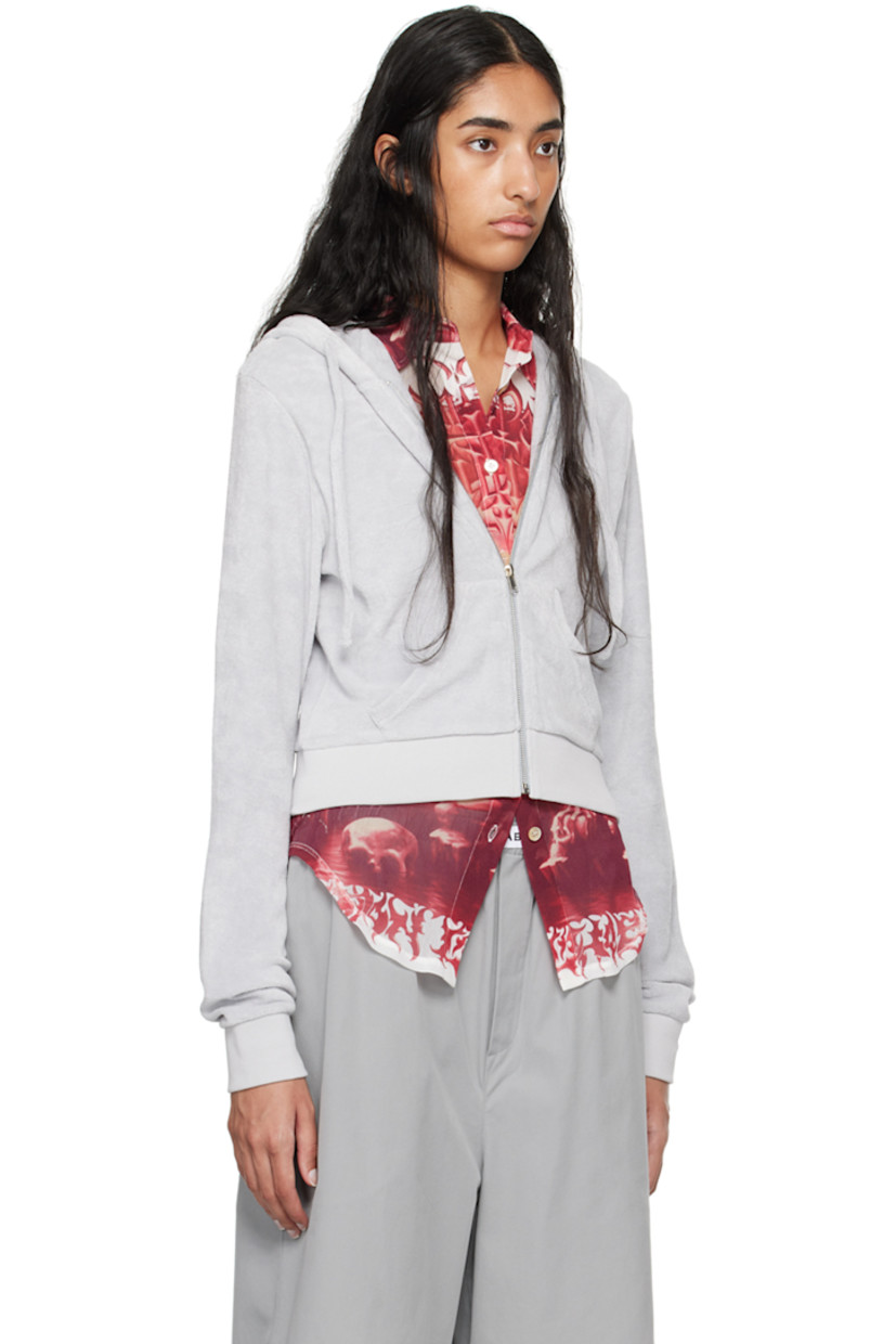 Organic cotton terrycloth hoodie. 

· Drawstring at hood
· Zip closure
· Logo embroidered at chest
· Welt pockets
· Rib knit cropped hem and cuffs

Supplier color: Grey