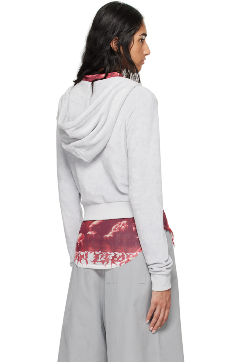 Organic cotton terrycloth hoodie. 

· Drawstring at hood
· Zip closure
· Logo embroidered at chest
· Welt pockets
· Rib knit cropped hem and cuffs

Supplier color: Grey