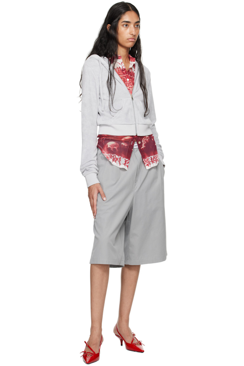 Organic cotton terrycloth hoodie. 

· Drawstring at hood
· Zip closure
· Logo embroidered at chest
· Welt pockets
· Rib knit cropped hem and cuffs

Supplier color: Grey