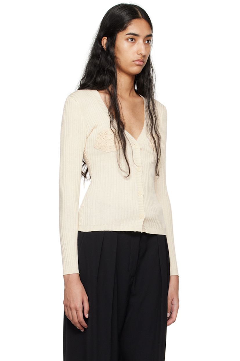 Lightweight rib knit cotton cardigan.

· Plunging V-neck
· Button closure
· Crocheted trim at cups

Supplier color: Cream