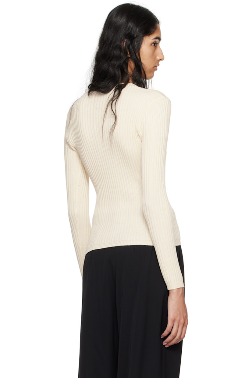 Lightweight rib knit cotton cardigan.

· Plunging V-neck
· Button closure
· Crocheted trim at cups

Supplier color: Cream