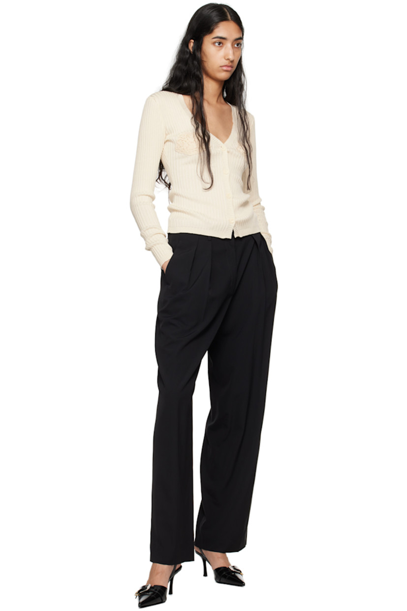 Lightweight rib knit cotton cardigan.

· Plunging V-neck
· Button closure
· Crocheted trim at cups

Supplier color: Cream