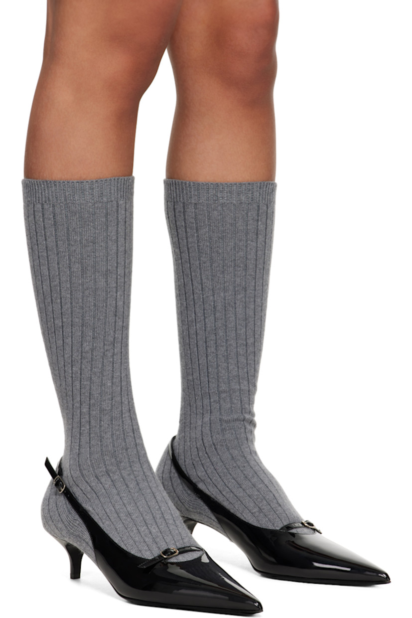 Mid-calf buffed calfskin heels in gray and black.

· Integrated sock-style rib knit wool collar
· Paneled and layered construction
· Pointed toe
· Pin-buckle strap at vamp and ankle
· Covered kitten heel with rubber injection
· Leather sole
· Heel: H2"

Supplier color: Grey