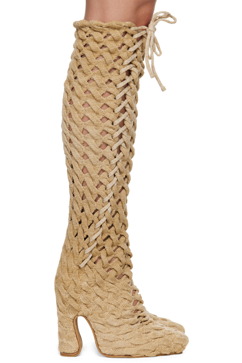Handcrafted thigh-high cable knit boots in beige.

· Self-tie lace-up detailing throughout
· Suede lining
· Covered block heel with rubber injection
· Leather sole
· Heel: H5"

Available exclusively at SSENSE.
 
Supplier color: Sand
