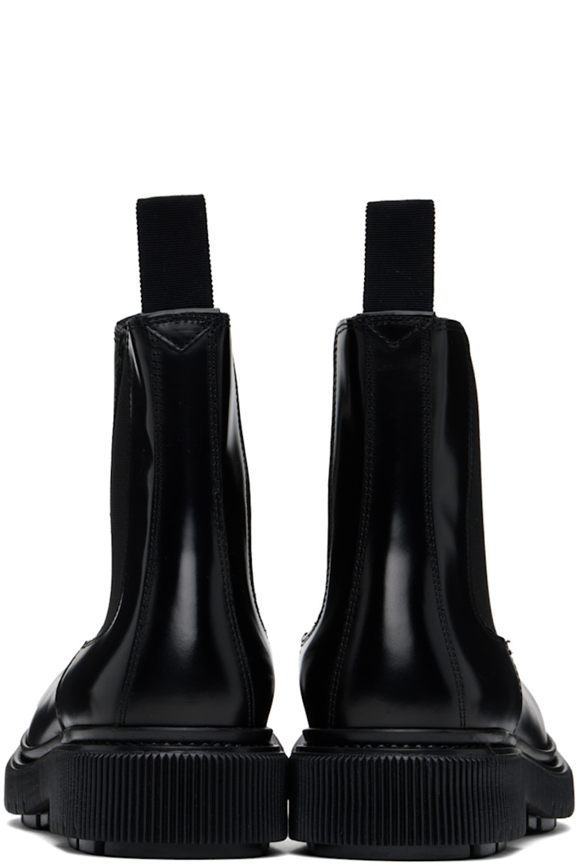 Ankle-high polished leather Chelsea boots in black.

· Elasticized gussets at sides
· Grosgrain pull-loops at collar
· Buffed leather and suede lining 
· Padded leather footbed
· Textured rubber midsole
· Injected treaded rubber sole
· Heel: H1.75"

Supplier color: Black
