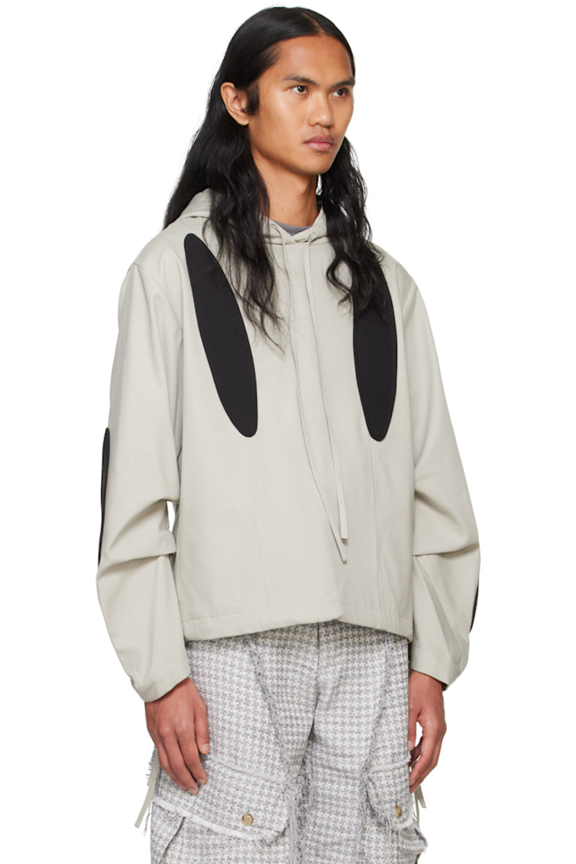 Coated cotton canvas jacket. Cotton twill graphic appliqués throughout.

· Drawstring at hood and hem
· Seam pockets
· Dropped shoulders
· Gathering at sleeves
· Fully lined

Supplier color: Grey/Black