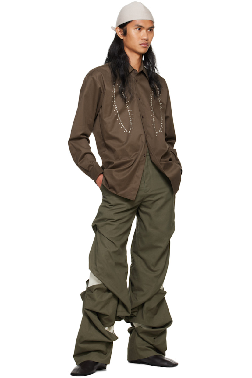 Cotton sateen shirt.

· Spread collar
· Button closure
· Graphic printed at front
· Droptail hem
· Pleated single-button barrel cuffs
· Box pleat at back yoke

Supplier color: Brown