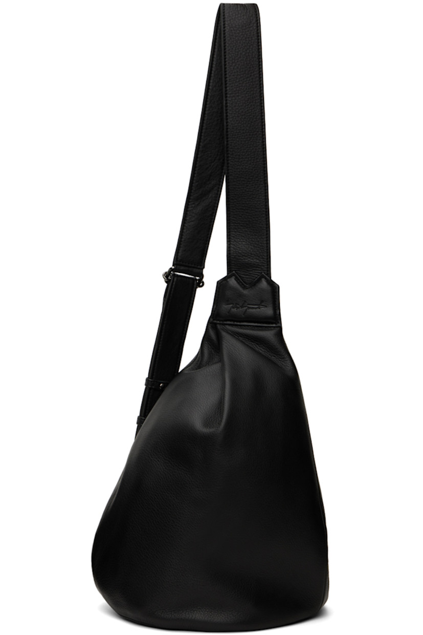 Grained leather shoulder bag in black.

· Adjustable and semi-detachable shoulder strap
· Pleat at face
· D-rings at back face
· Zip closure
· Zip pocket at interior
· Twill lining
· H14" x W8.5" x D5.5"

Supplier color: Black