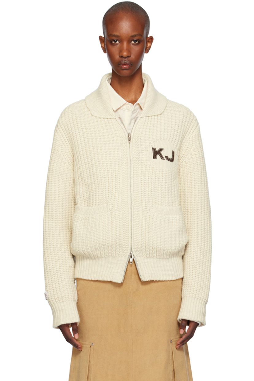 Rib knit wool- and nylon-blend cardigan. 

· Shawl collar
· Two-way zip closure
· Logo patch at chest and back collar
· Welt pockets
· Raglan sleeves
· Logo patch at sleeve
· Text appliqué at back

Supplier color: Ivory