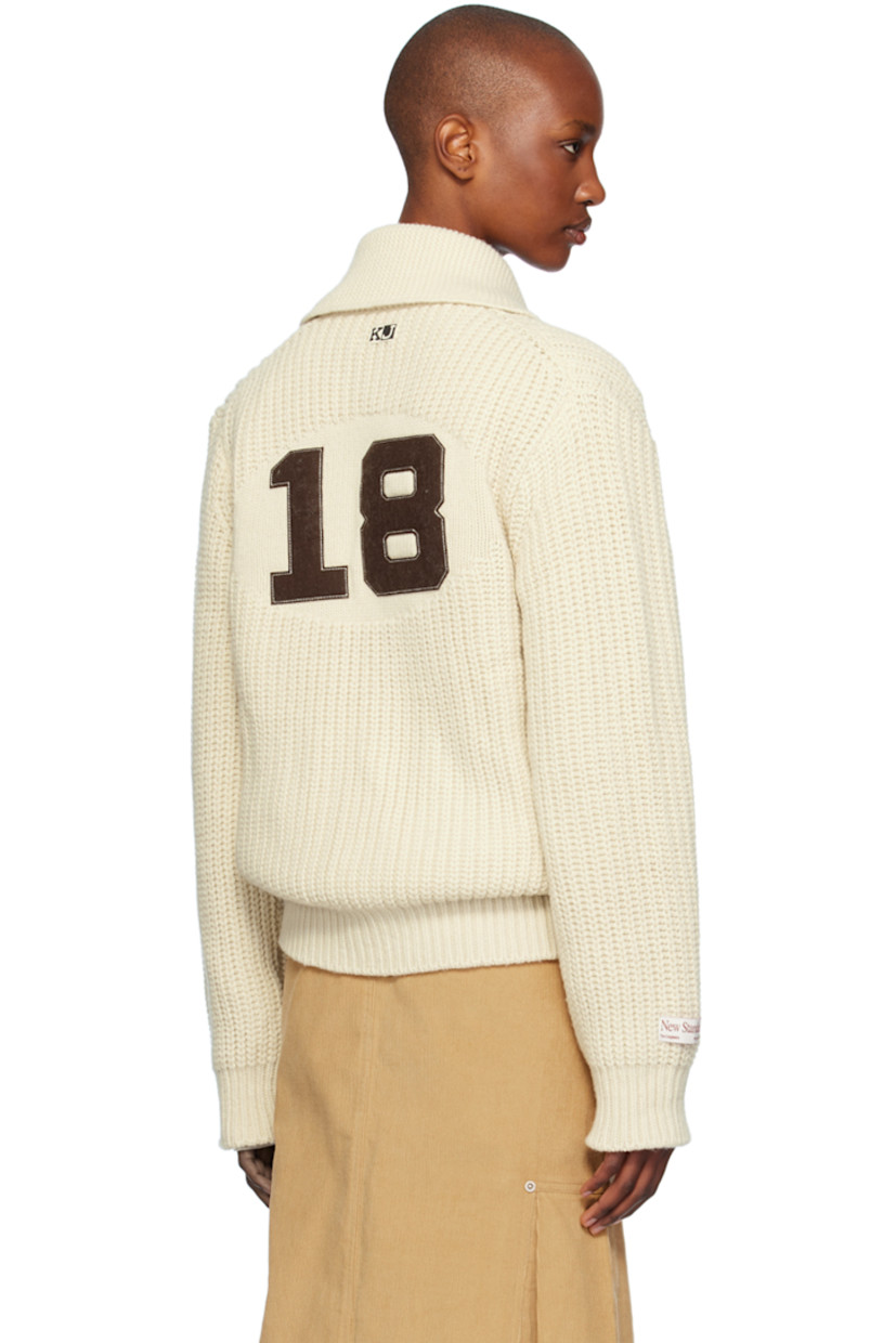 Rib knit wool- and nylon-blend cardigan. 

· Shawl collar
· Two-way zip closure
· Logo patch at chest and back collar
· Welt pockets
· Raglan sleeves
· Logo patch at sleeve
· Text appliqué at back

Supplier color: Ivory