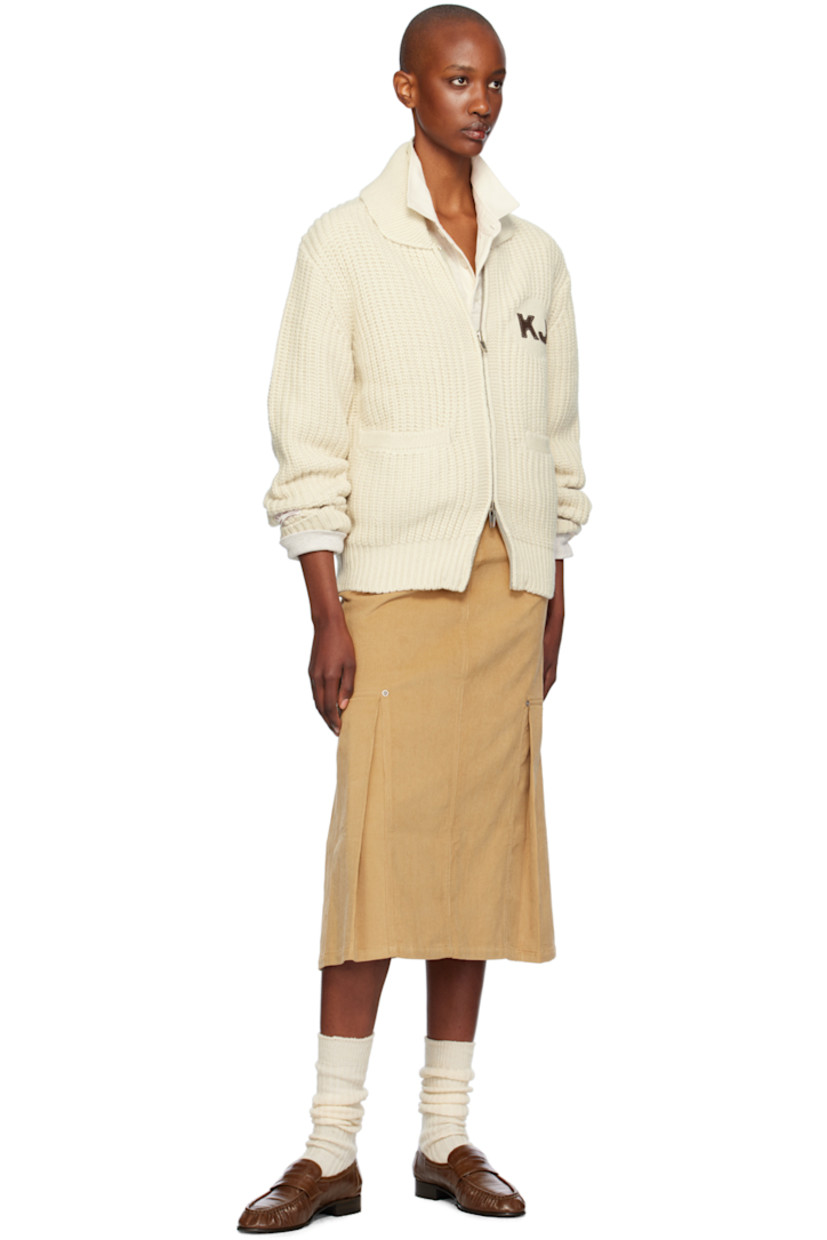 Rib knit wool- and nylon-blend cardigan. 

· Shawl collar
· Two-way zip closure
· Logo patch at chest and back collar
· Welt pockets
· Raglan sleeves
· Logo patch at sleeve
· Text appliqué at back

Supplier color: Ivory