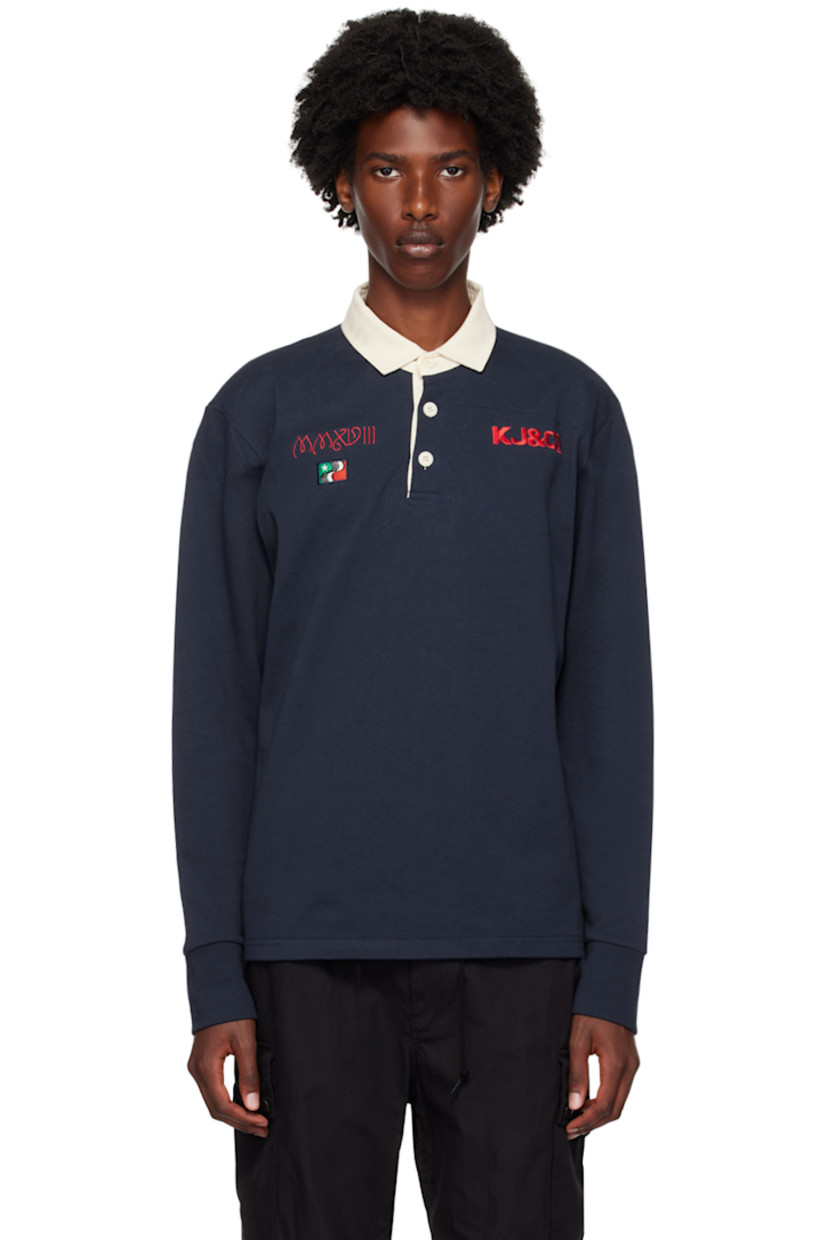 Cotton jersey polo. 

· Twill spread collar
· Three-button placket
· Logo, graphic, and text embroidered at chest
· Dropped shoulders
· Rib knit cuffs
· Logo and graphic patch at back 

Supplier color: Navy