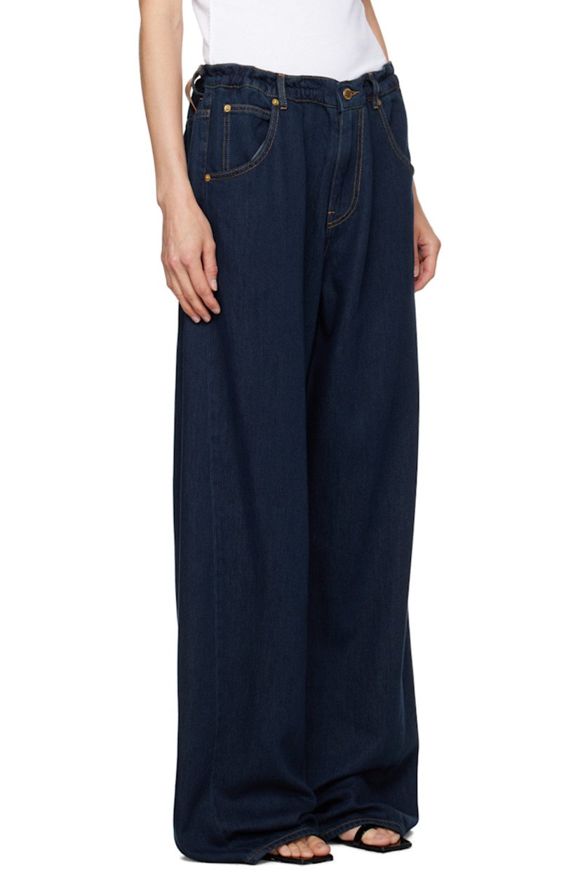 Baggy-fit wide-leg non-stretch denim jeans. 

· Mid-rise
· Belt loops
· Drawstring at waistband
· Five-pocket styling
· Zip-fly
· Dropped inseam
· Twisted outseams
· Leather logo patch at back waistband
· Gold-tone hardware
· Contrast stitching in tan

Supplier color: Deep Blue