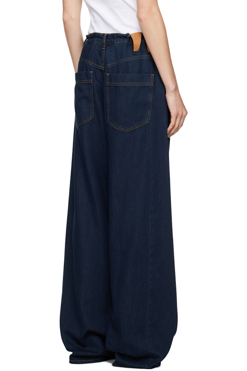 Baggy-fit wide-leg non-stretch denim jeans. 

· Mid-rise
· Belt loops
· Drawstring at waistband
· Five-pocket styling
· Zip-fly
· Dropped inseam
· Twisted outseams
· Leather logo patch at back waistband
· Gold-tone hardware
· Contrast stitching in tan

Supplier color: Deep Blue