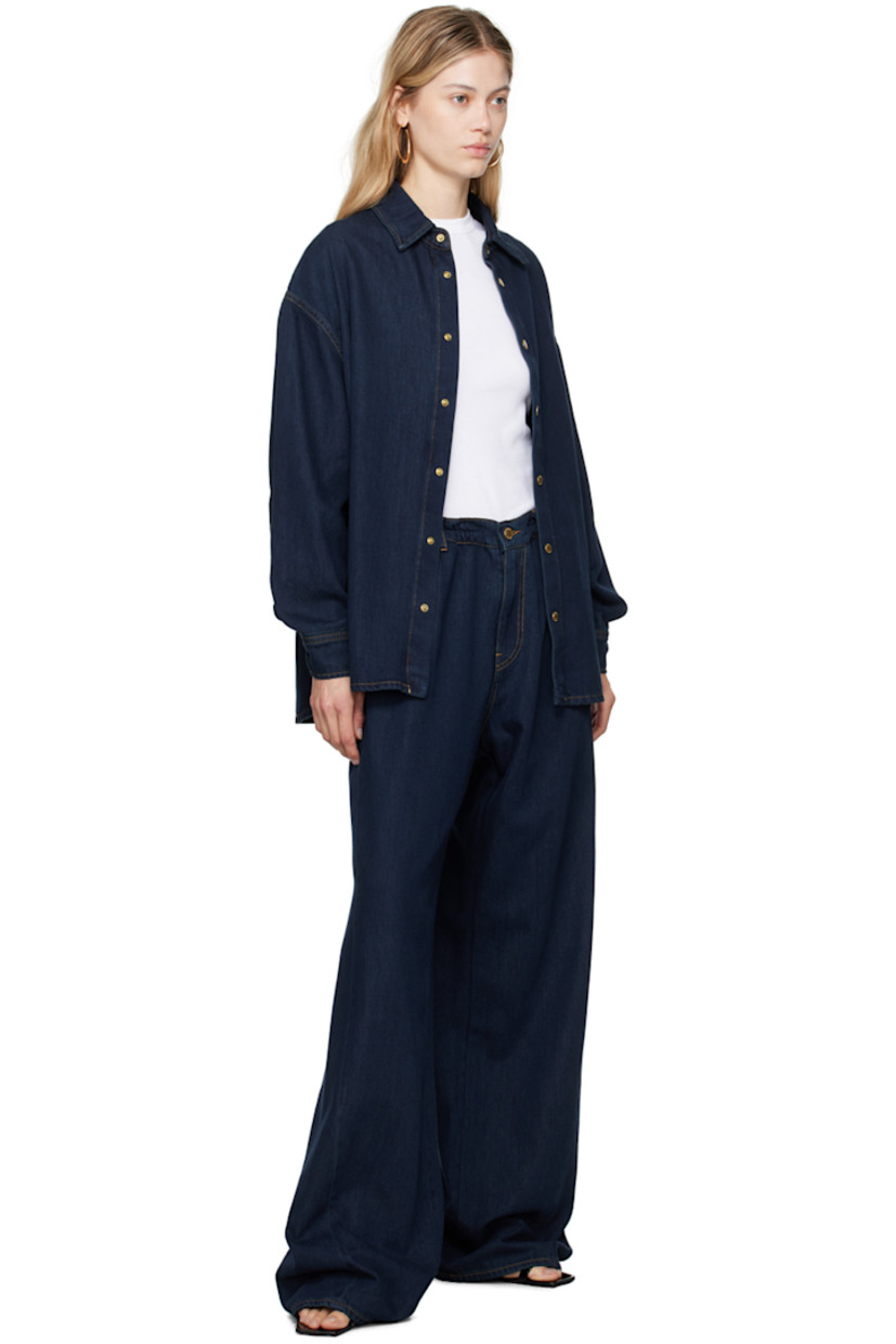 Baggy-fit wide-leg non-stretch denim jeans. 

· Mid-rise
· Belt loops
· Drawstring at waistband
· Five-pocket styling
· Zip-fly
· Dropped inseam
· Twisted outseams
· Leather logo patch at back waistband
· Gold-tone hardware
· Contrast stitching in tan

Supplier color: Deep Blue
