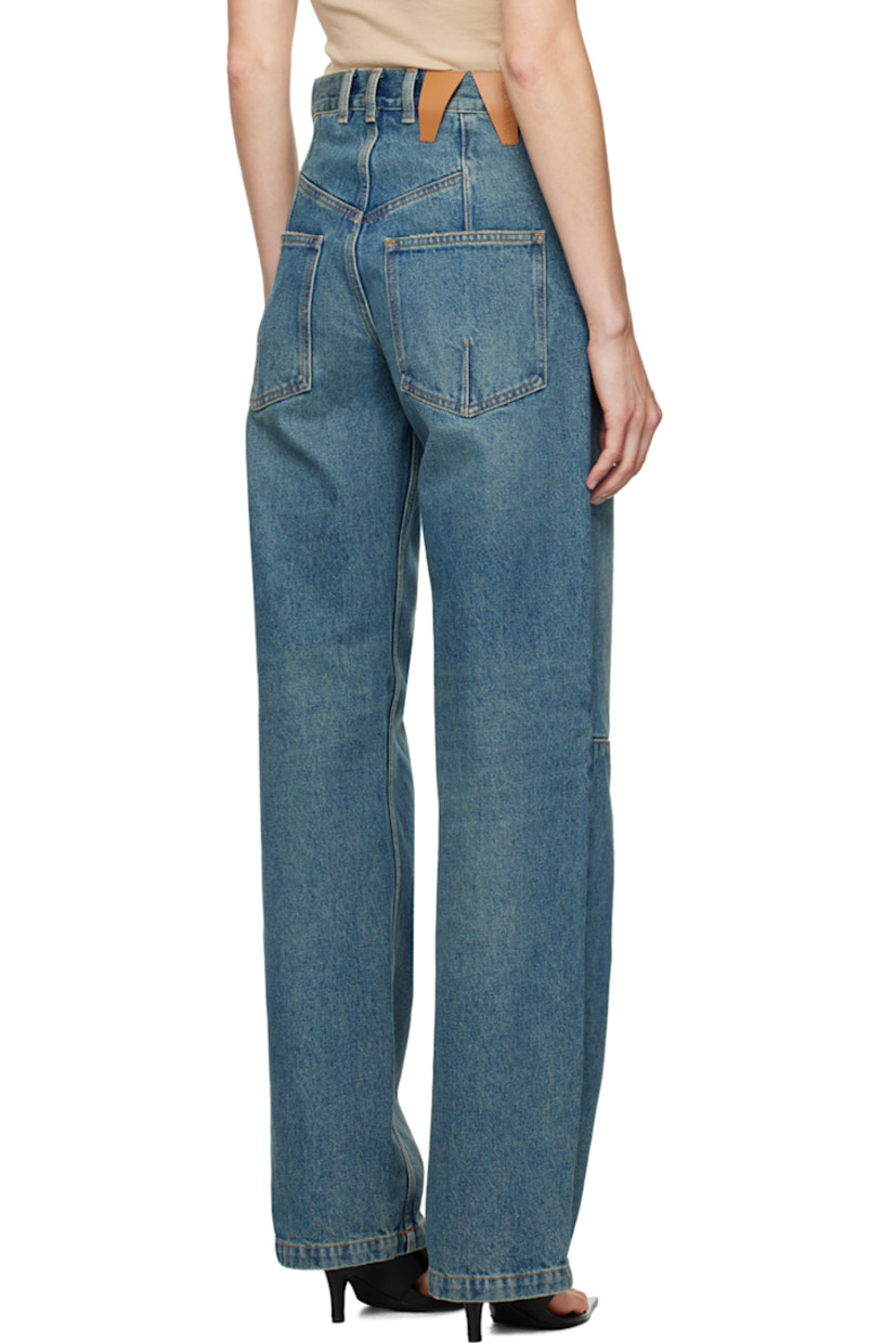Straight-leg non-stretch denim jeans. Fading throughout. 

· High-rise
· Belt loops
· Five-pocket styling
· Zip-fly
· Darts at legs 
· Logo patch at back waistband
· Contrast stitching in tan
· Logo-engraved gold-tone hardware

Supplier color: Sand wash