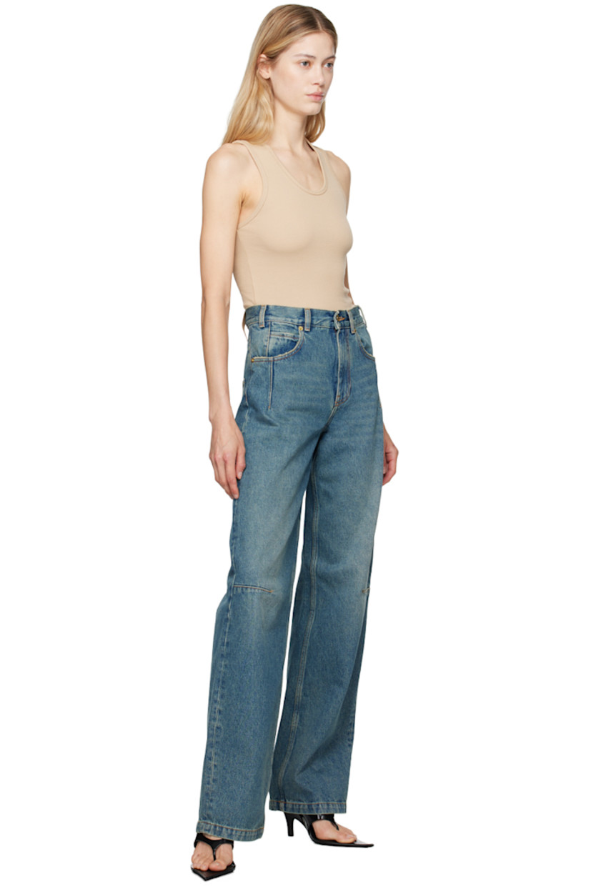 Straight-leg non-stretch denim jeans. Fading throughout. 

· High-rise
· Belt loops
· Five-pocket styling
· Zip-fly
· Darts at legs 
· Logo patch at back waistband
· Contrast stitching in tan
· Logo-engraved gold-tone hardware

Supplier color: Sand wash