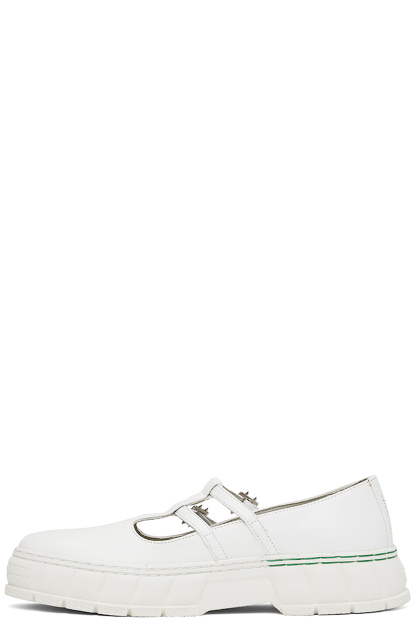Handcrafted Appleskin™ faux-leather Mary Jane-style loafers in white.

· PETA-certified
· Adjustable pin-buckle straps at vamp
· Text embossed at outer side
· Logo embossed at heel
· Logo printed at padded insole
· Grained faux-leather lining
· Textured recycled rubber-blend sole
· Contrast stitching in green

Supplier color: White