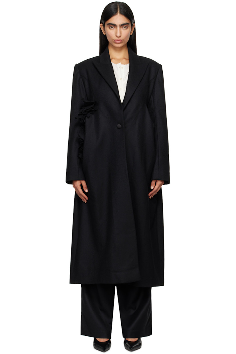 Wool melton coat. 

· Peaked lapel
· Single-button closure
· Floral appliqué at front
· Welt pockets
· Padded shoulders
· Three-button surgeon's cuffs
· Central vent at back hem 
· Full twill lining

Supplier color: Black