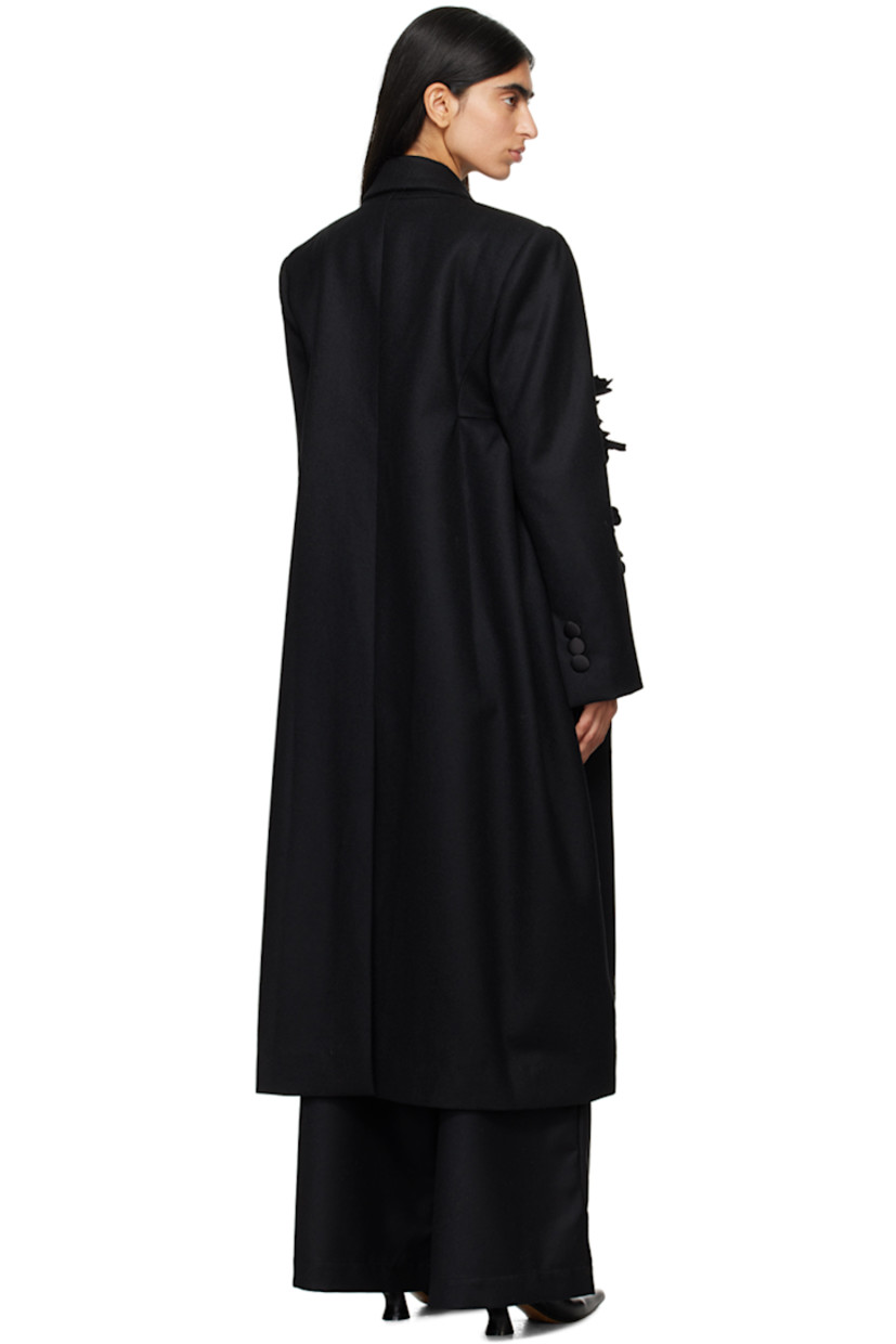 Wool melton coat. 

· Peaked lapel
· Single-button closure
· Floral appliqué at front
· Welt pockets
· Padded shoulders
· Three-button surgeon's cuffs
· Central vent at back hem 
· Full twill lining

Supplier color: Black