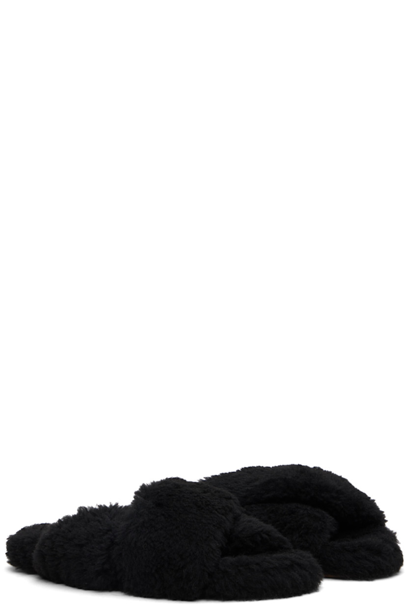 Shearling slippers in black.

· Open toe
· Criss-crossing straps at vamp
· Logo-embossed leather patch at footbed
· Treaded rubber sole

Supplier color: Black