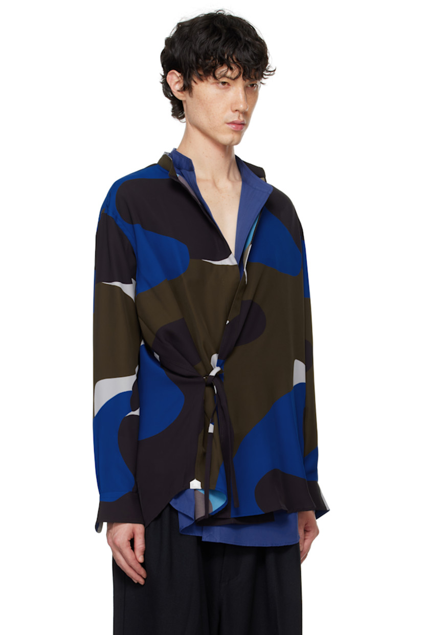 Polyester twill shirt. Graphic pattern printed throughout.

· Band collar
· Self-tie closure
· Shirttail hem
· Logo patch at side seams
· Single-button barrel cuffs
· Locker loop and box pleat at back yoke

Supplier color: Pattern