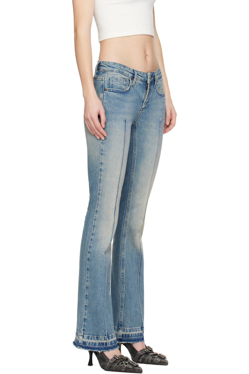 Flared stretch denim jeans. Fading, whiskering, and subtle distressing throughout. 

· Mid-rise
· Belt loops
· Five-pocket styling
· Pinched seam at legs
· Raw edge at cuffs
· Logo patch at back pocket

Supplier color: Used indigo