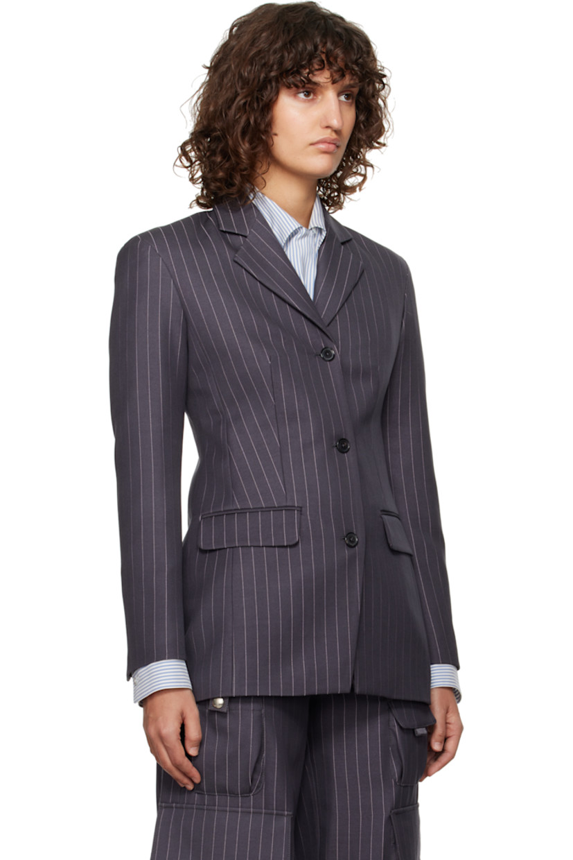 Virgin wool-blend twill blazer. Pinstripes throughout.

· Notched lapel
· Button closure
· Flap pockets
· Padded shoulders
· Logo embroidered at cuff
· Four-button surgeon's cuffs
· Central vent at back hem
· Full logo-woven viscose satin lining

Supplier color: Forged iron