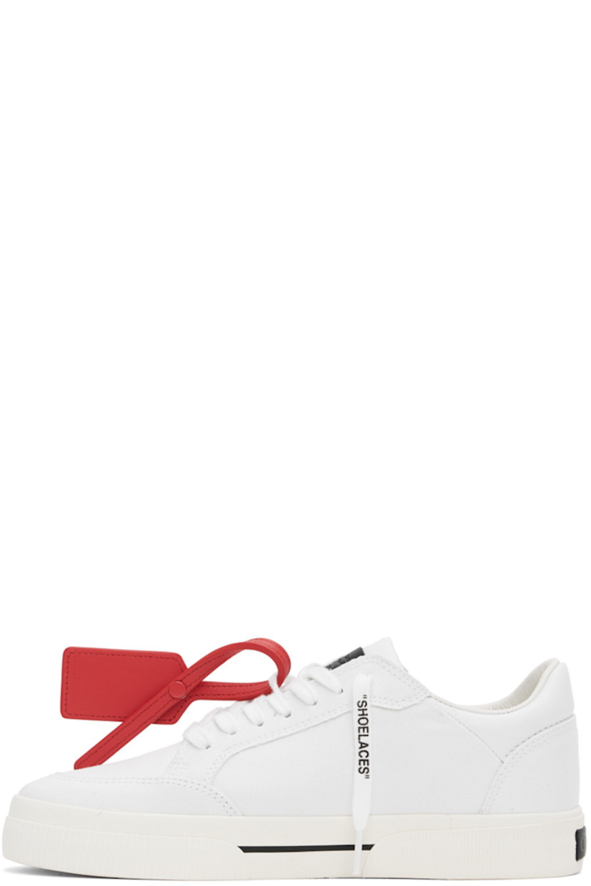 Low-top paneled canvas sneakers in white. 

· Signature zip-tie at lace-up closure
· Leather logo patch at padded tongue
· Padded collar
· Logo embroidered at outer side
· Rubber logo patch at heel
· Grained leather and suede lining
· Textured rubber midsole 
· Treaded vulcanized rubber sole

Supplier color: White/Black