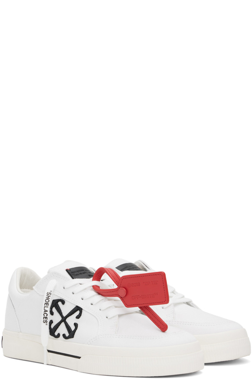 Low-top paneled canvas sneakers in white. 

· Signature zip-tie at lace-up closure
· Leather logo patch at padded tongue
· Padded collar
· Logo embroidered at outer side
· Rubber logo patch at heel
· Grained leather and suede lining
· Textured rubber midsole 
· Treaded vulcanized rubber sole

Supplier color: White/Black