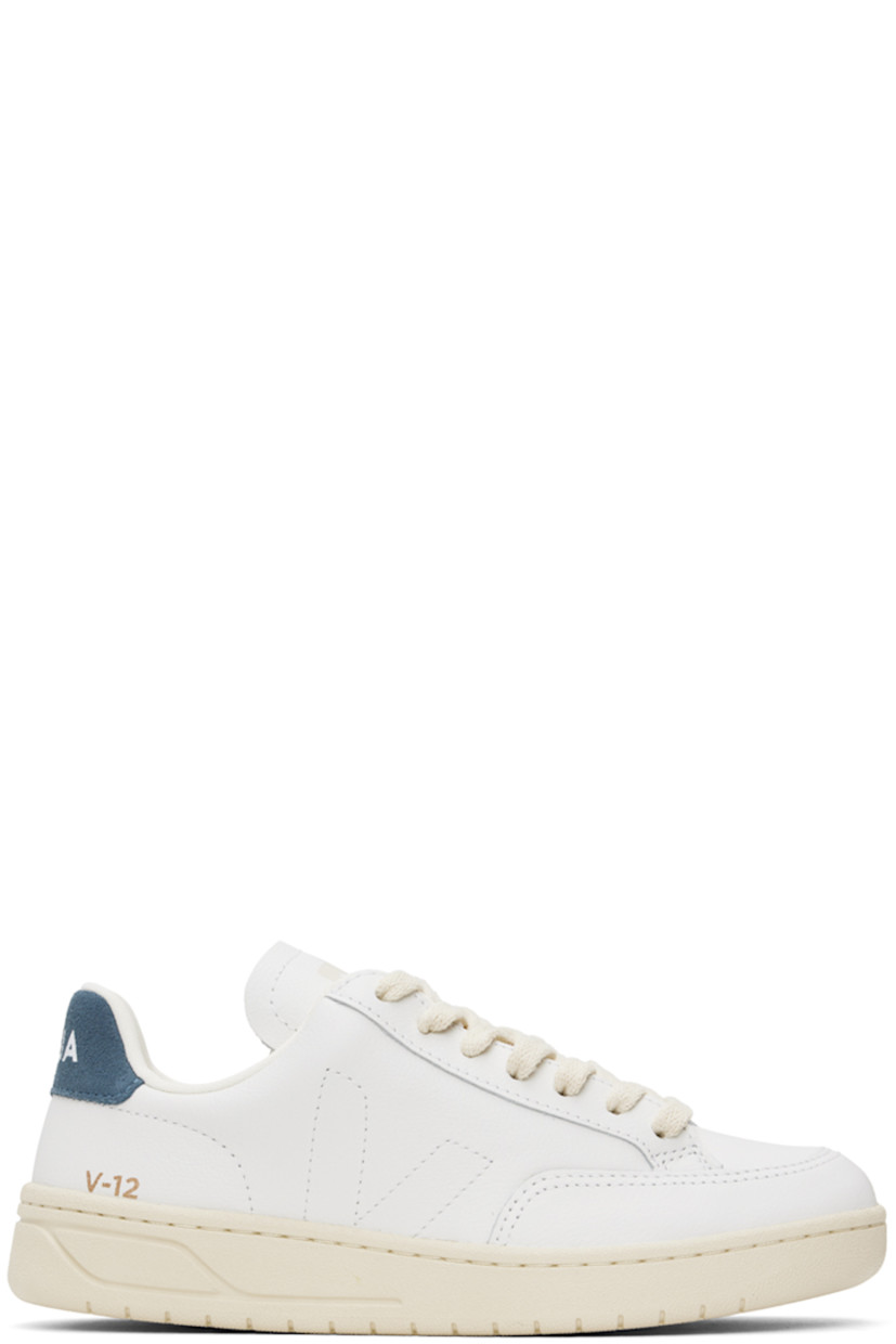 Low-top Organic Traced grained leather sneakers in white and navy.

· Lace-up closure
· Logo printed at padded tongue
· Padded collar
· Logo stitched at sides
· Logo stamp at outer side
· Logo printed at suede heel tab
· Recycled polyester jersey lining
· Treaded rubber sole

Supplier color: Extra white/California